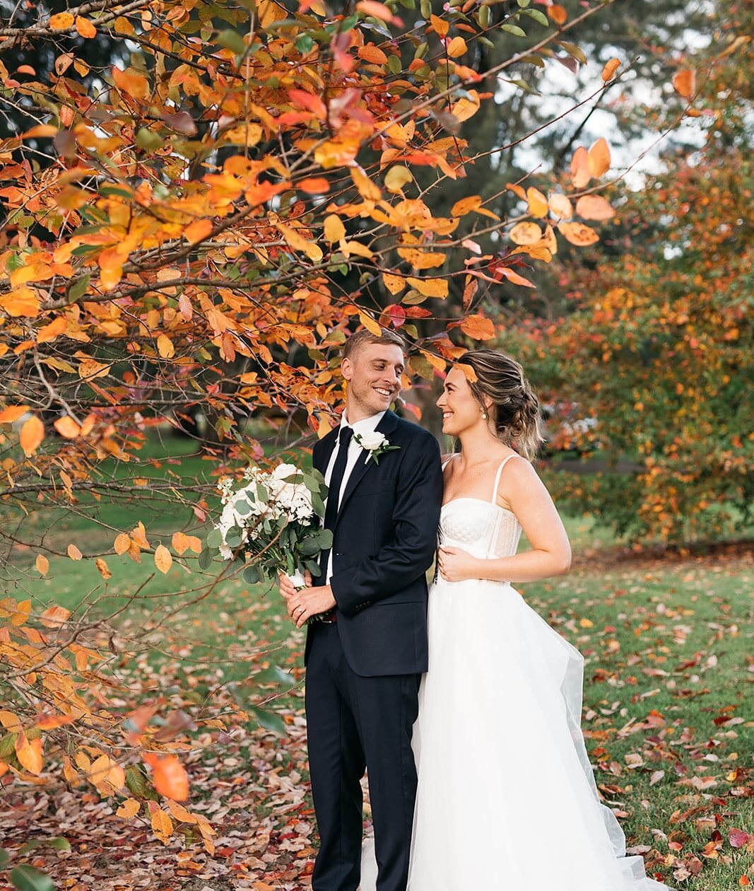 A couple under a red autumn tree