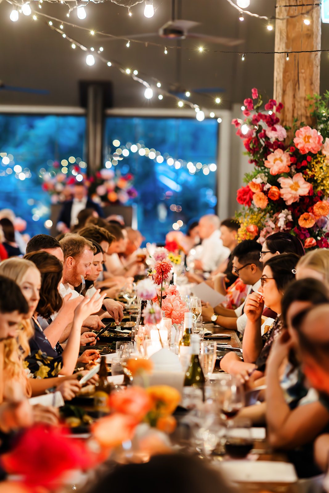 A packed dance floor under fairy lights