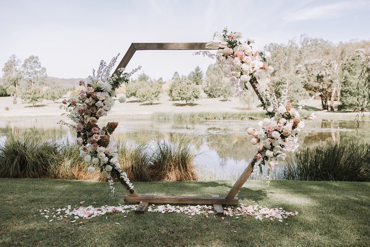 A hexagon arbour set by the lake under the willows